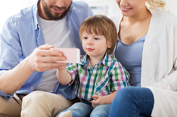 Image showing happy family with smartphone at home