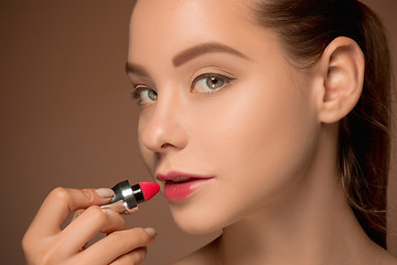 Image showing Beautiful female lips with make-up and brush