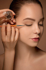 Image showing Beautiful female eyes with make-up and brush