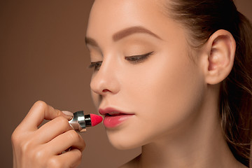 Image showing Beautiful female lips with make-up and brush