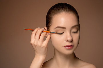 Image showing Beautiful female eyes with make-up and brush