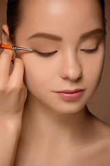 Image showing Beautiful female eyes with make-up and brush