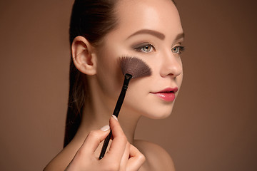 Image showing Beauty Girl with Makeup Brush. Perfect Skin. Applying Makeup