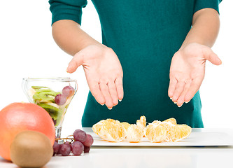 Image showing Cook is making fruit dessert