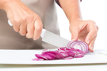 Image showing Cook is chopping onion