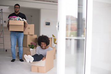 Image showing African American couple  playing with packing material