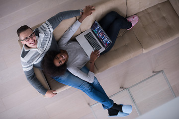 Image showing happy multiethnic couple relaxes in the living room