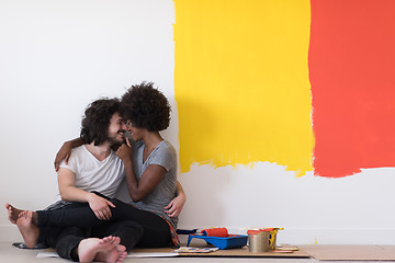 Image showing young multiethnic couple relaxing after painting