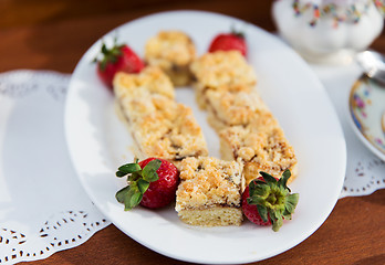 Image showing pieces of cake or pie and strawberries on plate