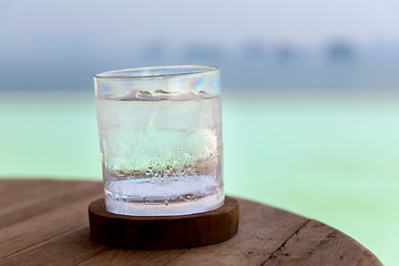 Image showing glass with cold water or cocktail on bar table