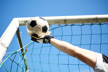 Image showing goalkeeper with ball at football goal over sky