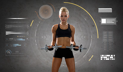 Image showing happy young sporty woman exercising with dumbbells