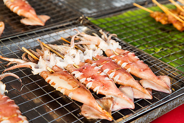 Image showing squids on grill at street market