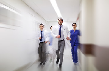 Image showing group of medics walking along hospital