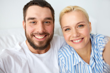 Image showing happy couple taking selfie at home