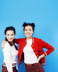 Image showing best friends teenage school girls together having fun, posing emotional on blue background, besties happy smiling, lifestyle people concept 