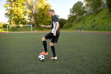 Image showing soccer player playing with ball on football field