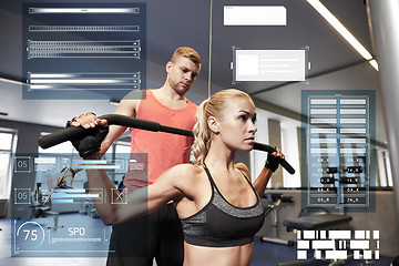 Image showing man and woman flexing muscles on gym machine