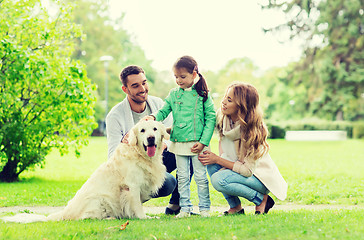 Image showing happy family with labrador retriever dog in park