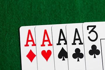 Image showing poker hand of playing cards on green casino cloth