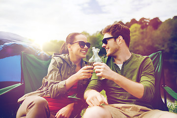 Image showing happy couple clinking drinks at campsite tent