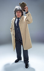 Image showing The senior man as detective or boss of mafia on gray studio background