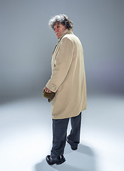 Image showing The senior man as detective or boss of mafia on gray studio background