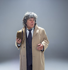 Image showing The senior man as detective or boss of mafia on gray studio background