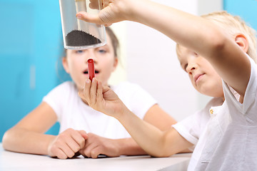 Image showing Young explorer. Lesson physics. Physical experiment. The joy of discovery.