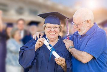 Image showing Senior Adult Woman In Cap and Gown Being Congratulated By Husban