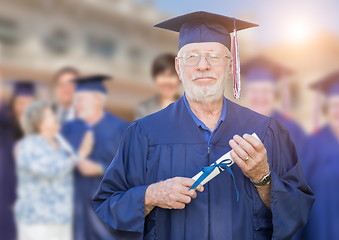 Image showing Proud Senior Adult Man In Cap and Gown At Outdoor Graduation Cer