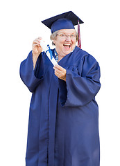 Image showing Happy Senior Adult Woman Graduate In Cap and Gown Holding Diplom