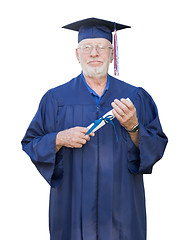 Image showing Proud Senior Adult Man Graduate In Cap and Gown Holding Diploma 