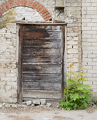 Image showing wooden plank door, dirty grunge brick wall