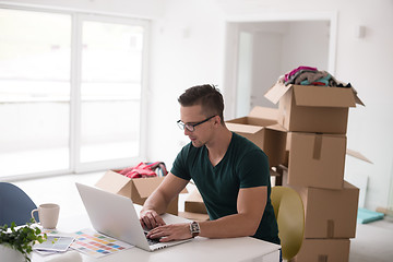 Image showing Young man moving in a new home