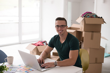 Image showing Young man moving in a new home