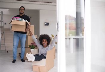 Image showing African American couple  playing with packing material