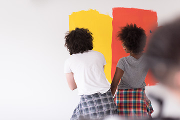 Image showing multiethnic couple painting interior wall