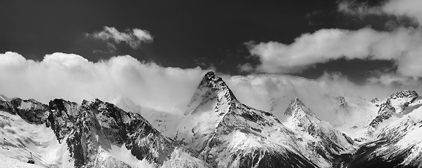 Image showing Black and white panorama of snowy mountains in clouds