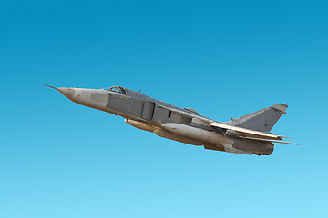 Image showing Military jet bomber Su-24 Fencer flying a blue background