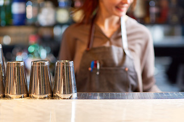 Image showing woman bartender and shakers at bar