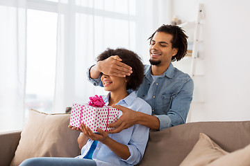 Image showing happy couple with gift box at home