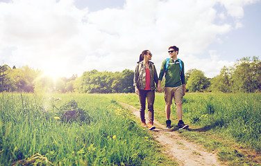 Image showing happy couple with backpacks hiking outdoors