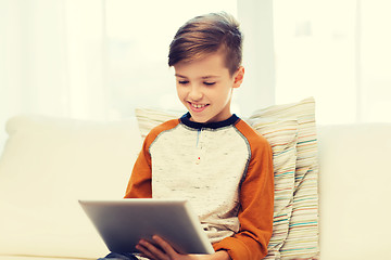 Image showing smiling boy with tablet computer at home