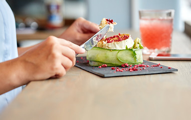 Image showing woman eating goat cheese salad at restaurant