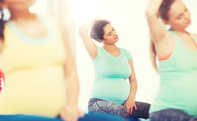 Image showing happy pregnant women exercising on fitball in gym