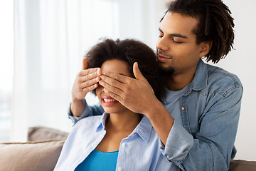 Image showing happy man closing woman eyes at home