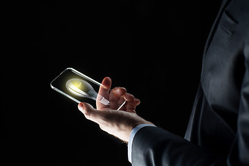 Image showing businessman with lightbulb on smartphone