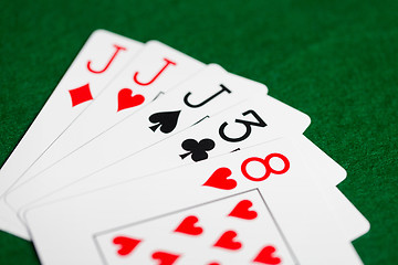 Image showing poker hand of playing cards on green casino cloth