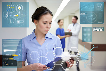 Image showing female doctor or nurse with clipboard at hospital